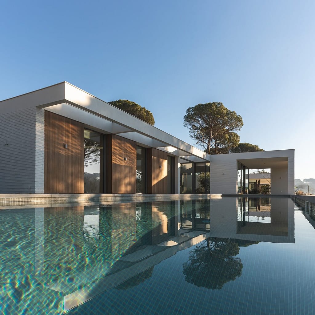 Modern white and wood luxury house with pool in a private complex. Vertical